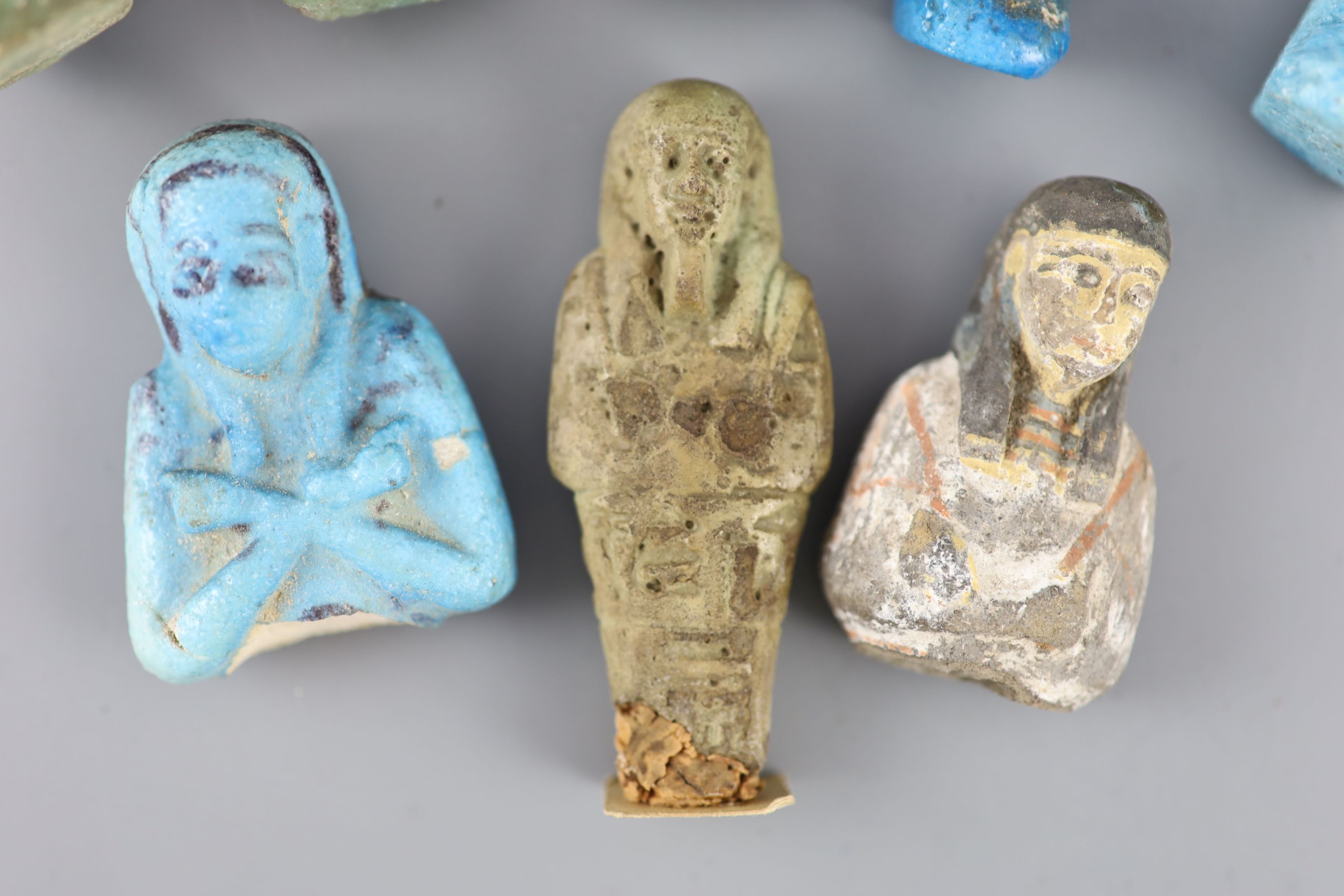 Five Egyptian turquoise glazed faience shabti and three fragments, New Kingdom to late period, Provenance - A. T. Arber-Cooke